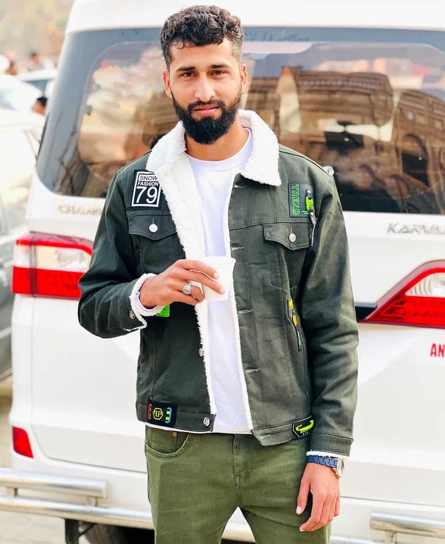 Portrait of Bilal A Muhammadi, AI solutions expert, wearing a green sherpa-collar denim jacket